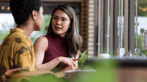 Two professional women talking in office while keeping calm