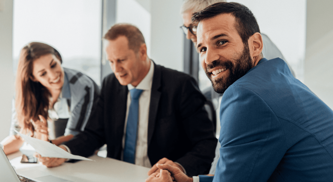 Man smiling during a work meeting