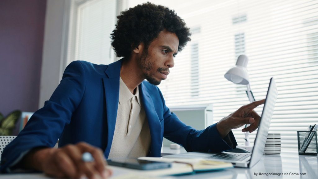 man working at a desk with laptop