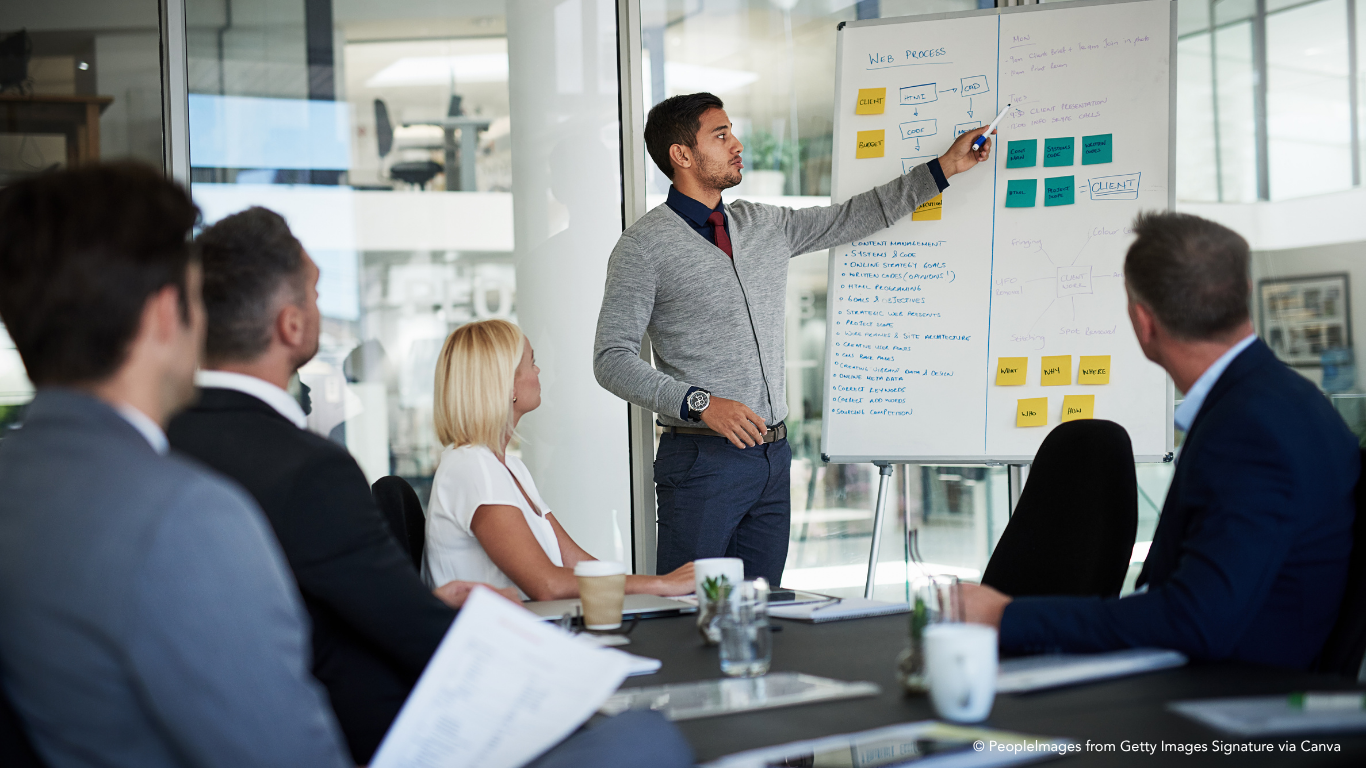 man presenting to executives